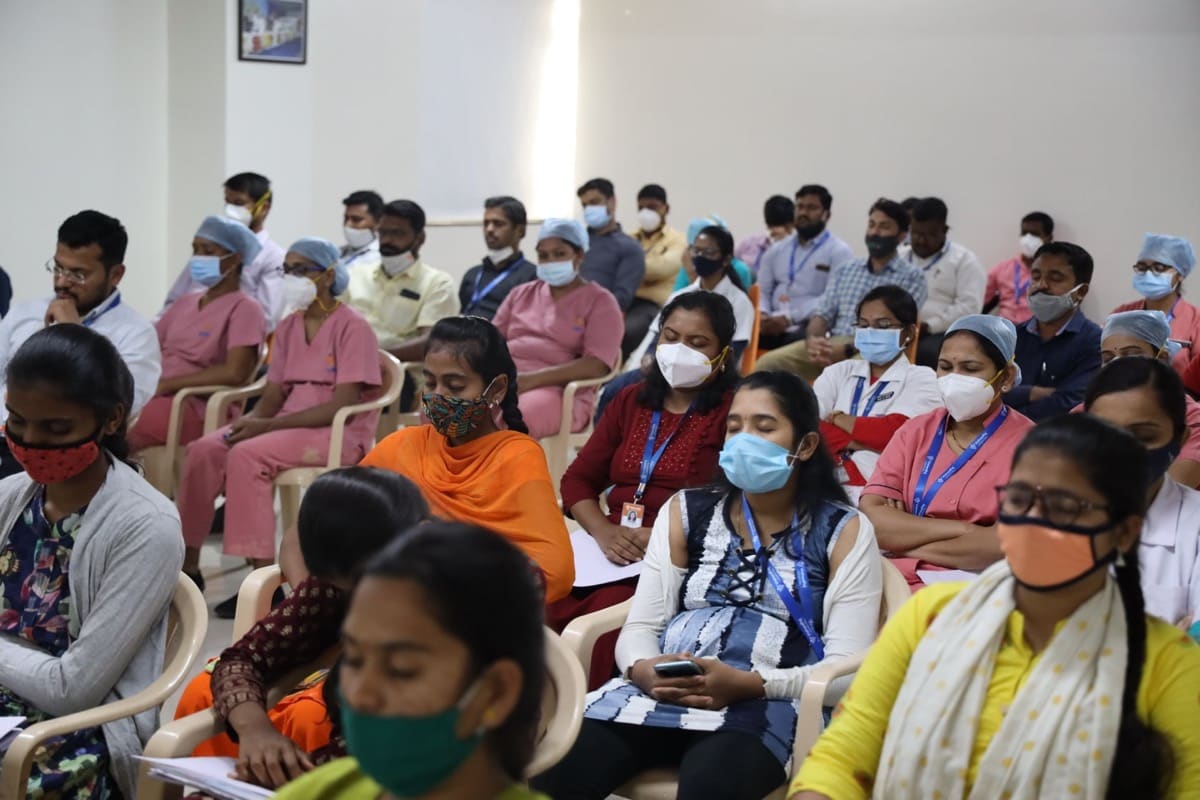 A diverse audience, including healthcare professionals, attending a seminar.